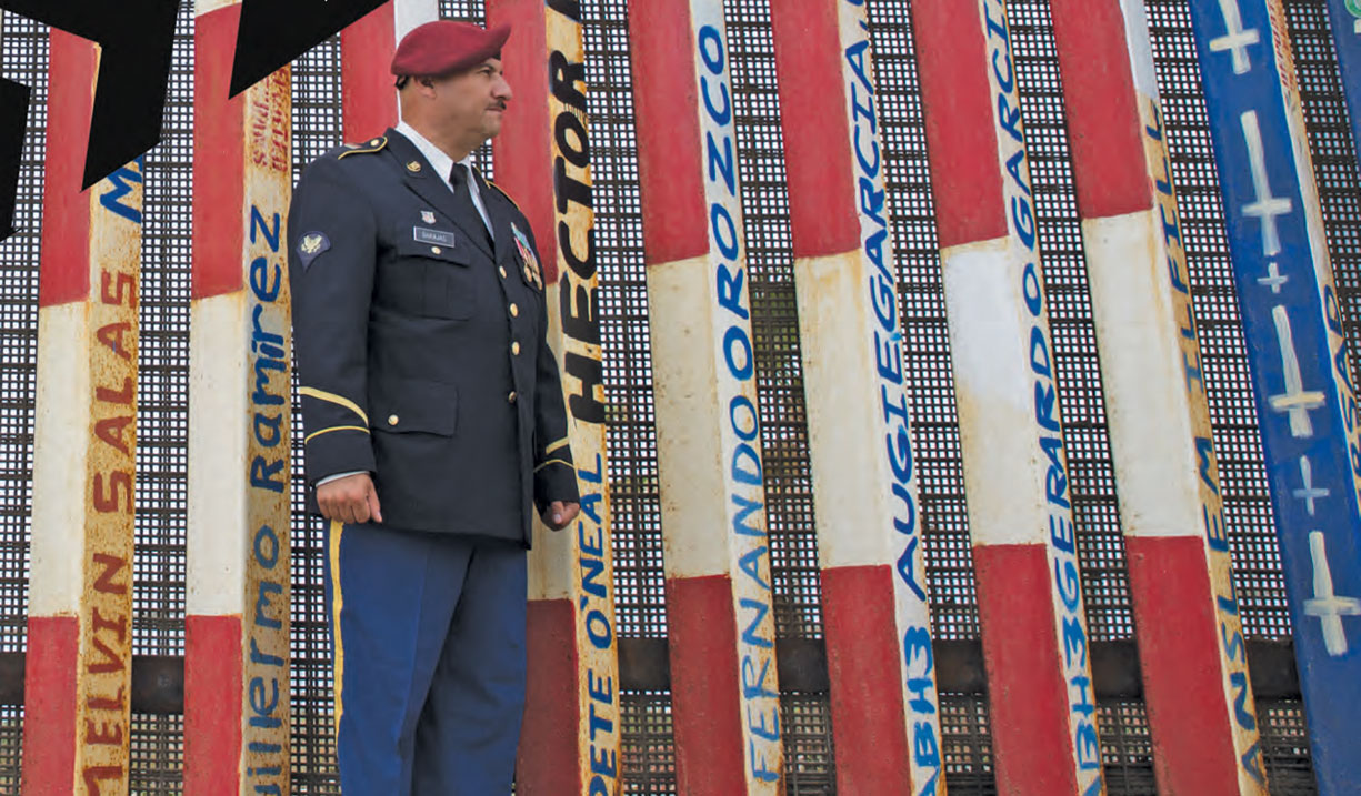 U.S. Army Veteran Hector Barajas in his uniform, standing near the U.S. border. Discharged, then Discarded: How U.S. Veterans are Banished by the Country They Swore to Protect