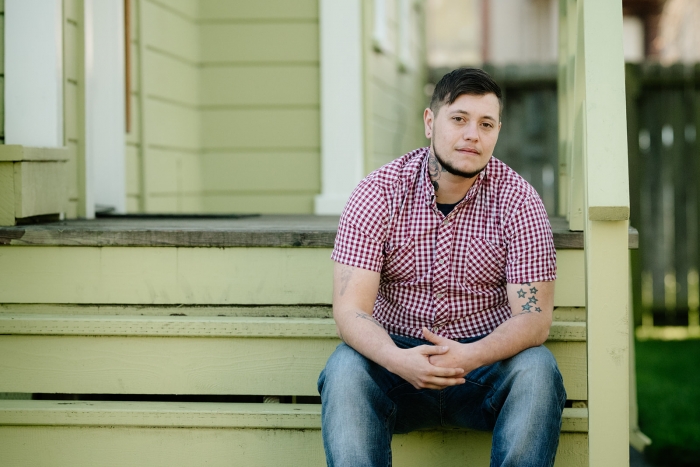 Oliver Knight sitting on the steps of a porch