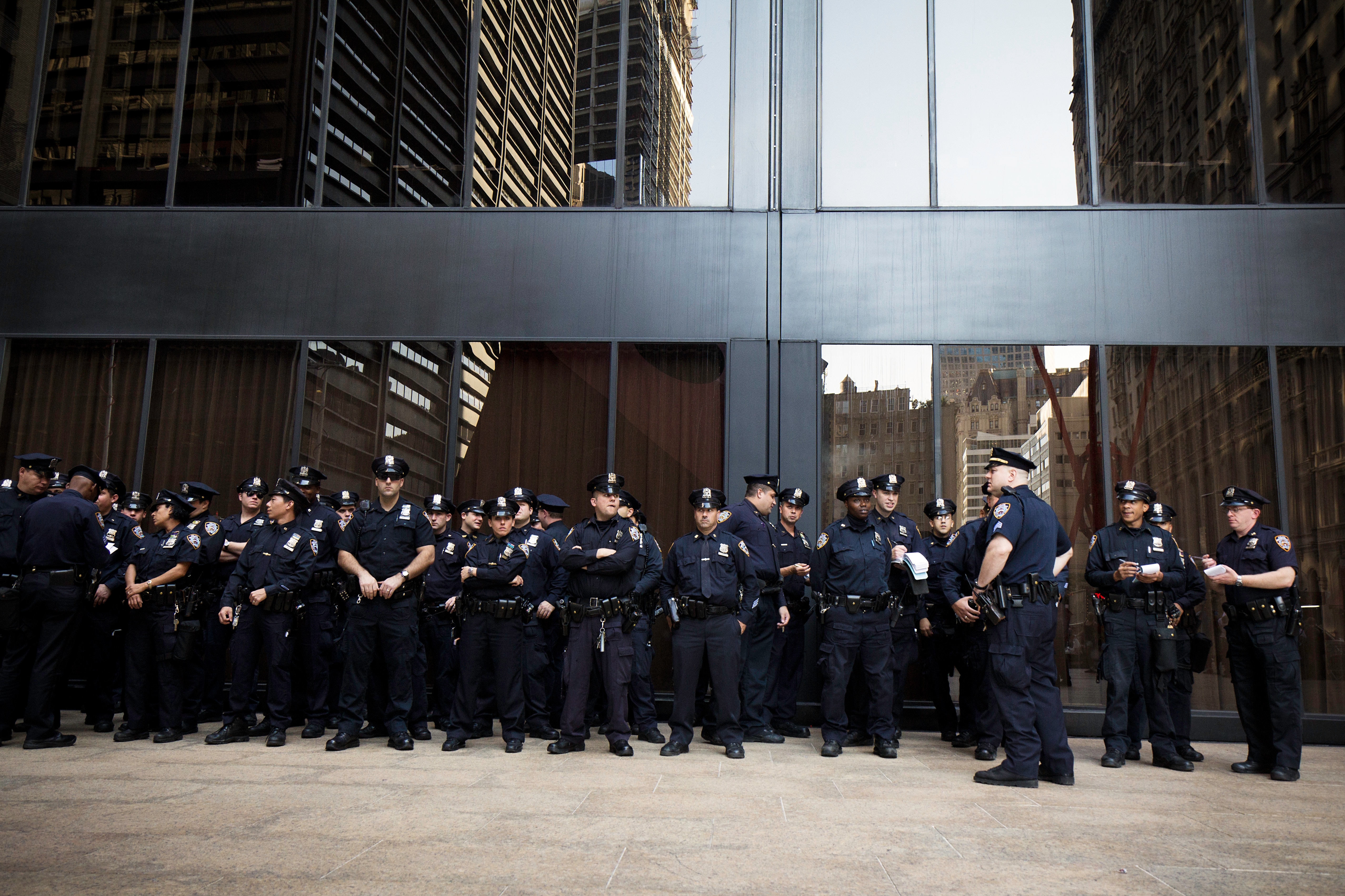 A large group of police officers standing in front of a building