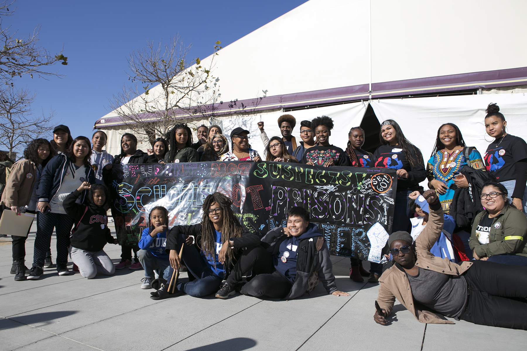 LAUSD student activists gathering around a banner that reads: Students Not Suspects