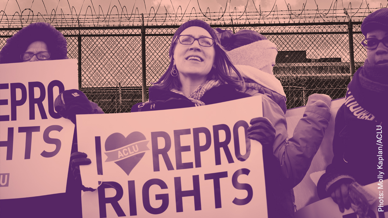 A woman at a protest holding a sign that reads 'I heart repro rights'